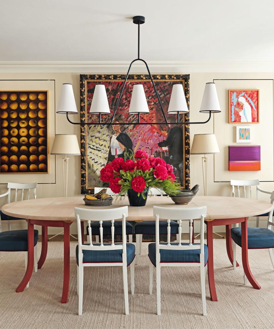 Wooden table, red legs, white chairs, blue cushions