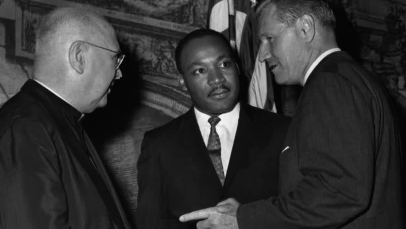 Civil rights leader Dr. Martin Luther King, Jr., center, talks with Francis Cardinal Spellman, archbishop of New York, left, and Gov. Nelson Rockefeller at a dinner in New York commemorating the centennial of the Emancipation Proclamation, Sept. 12, 1962.