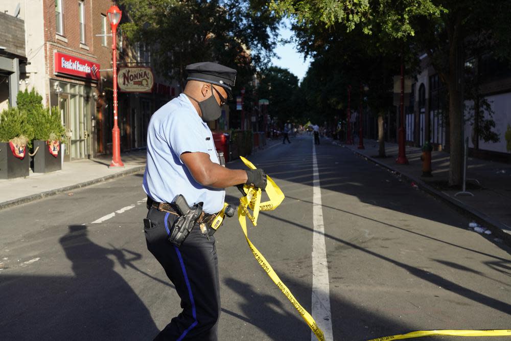 Philadelphia Police investigators work the scene of a fatal overnight shooting on South Street in Philadelphia, Sunday, June 5, 2022. (AP Photo/Michael Perez)