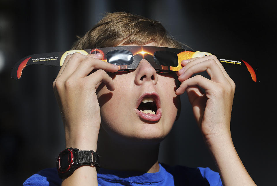 <p>In this Wednesday, Aug. 16, 2017 photo, Colton Hammer tries out his new eclipse glasses he just bought from the Clark Planetarium in Salt Lake City, Utah, in preparation for the eclipse. (Photo: Scott G Winterton/The Deseret News via AP) </p>