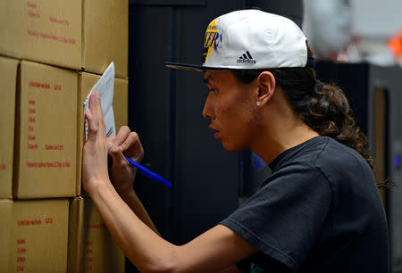 Terrell Elk, 18, voting for the first time, fills out an absentee ballot for the 2018 mid-term election outside the Sioux County Auditor's office on the Standing Rock Reservation in Fort Yates, North Dakota, U.S. October 26, 2018. REUTERS/Dan Koeck