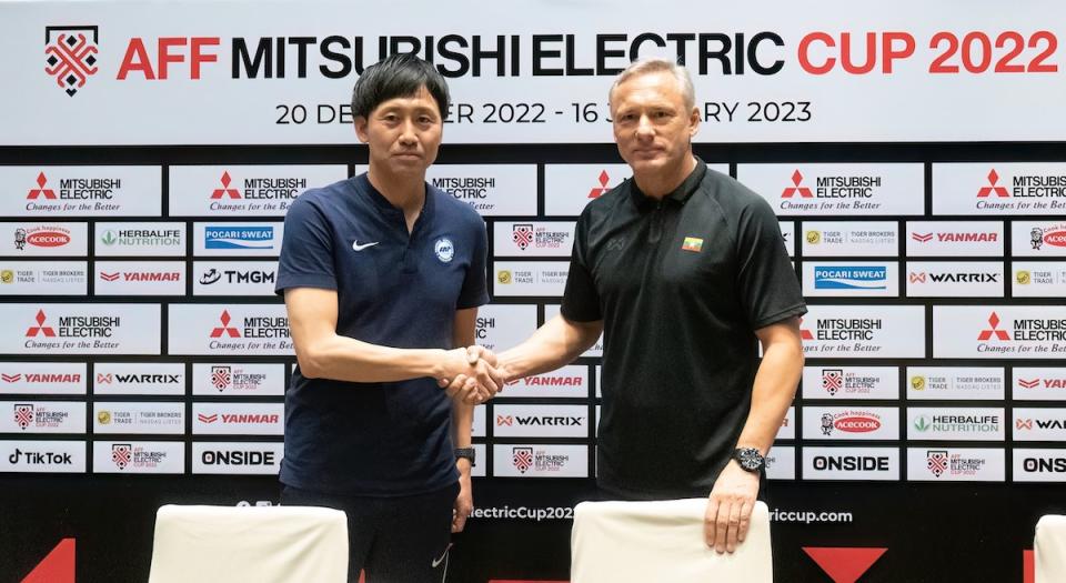 Singapore coach Takayuki Nishigaya (left) and Myanmar coach Antoine Hey shake hands ahead of their AFF Mitsubishi Electric Cup match. (PHOTO: AFF Mitsubishi Electric Cup)