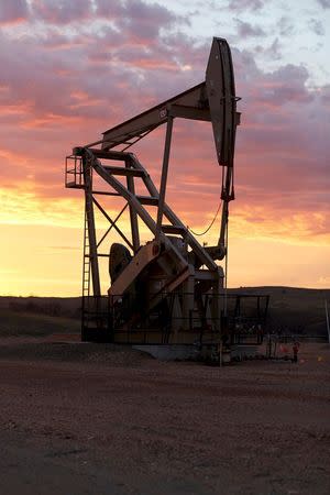 An oil well is pictured at sunrise in the Bakken oil fields near Sidney, Montana in this November 2014 handout photo. REUTERS/Smithsonian Channel/Handout via Reuters