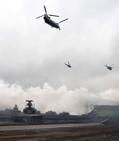 Japanese Ground Self-Defense Force tanks and other armoured vehicles take part in an annual training session near Mount Fuji at Higashifuji training field in Gotemba, west of Tokyo, August 19, 2014. REUTERS/Yuya Shino