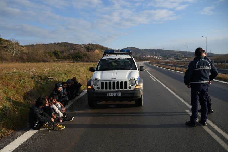 Migrants from Pakistan are detained by Greek police after crossing from Turkey to Greece, near the city of Didymoteicho, in the region of Evros