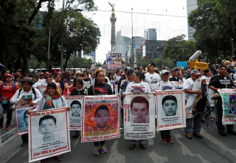 FILE PHOTO: A relative of a missing student holds a poster with the image of Christian Alfonso Rodriguez Telumbre during a march in Mexico City