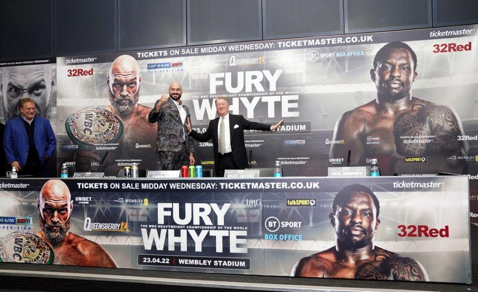 Promoter Frank Warren and Tyson Fury mock a face-off in the absence of Dillian Whyte (John Walton/PA) (PA Wire)