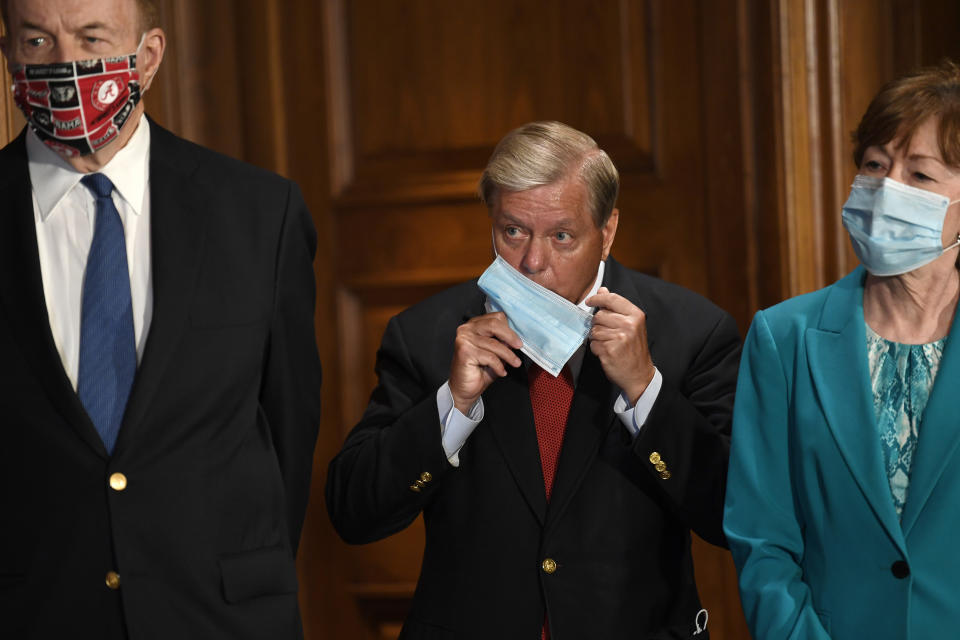 Sen. Richard Shelby, R-Ala., left, Sen. Lindsey Graham, R-S.C., center, and Sen. Susan Collins, R-Maine, right, listen during a news conference on on Capitol Hill in Washington, Monday, July 27, 2020, to highlight the new Republican coronavirus aid package. (AP Photo/Susan Walsh)