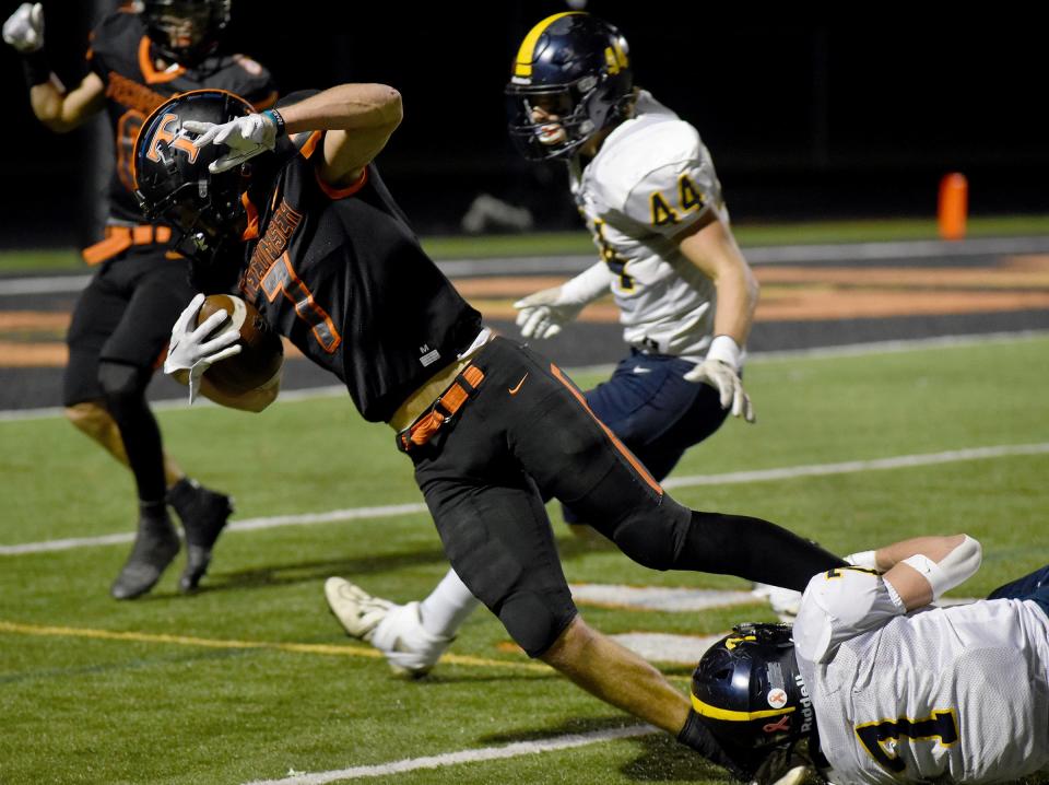 Owen Verduyn of Airport makes an ankle tackle on AJ Bryan of Tecumseh during a 52-28 Tecumseh win in the opening round of the Division 4 state playoffs Friday night.