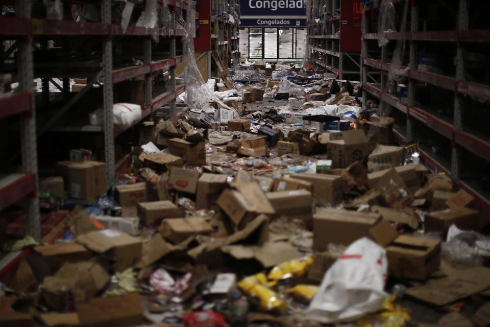 Goods and groceries lay strewn on the floor of a looted supermarket in Santiago, Chile, Tuesday, Oct. 22, 2019. Chile has been facing days of unrest, triggered by a relatively minor increase in subway fares. The protests have shaken a nation noted for economic stability over the past decades, which has seen steadily declining poverty despite persistent high rates of inequality. (AP Photo/Luis Hidalgo)