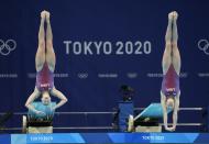 Alison Gibson and Krysta Palmer of the United States' compete during the Women's Synchronized 3m Springboard Final at the Tokyo Aquatics Centre at the 2020 Summer Olympics, Sunday, July 25, 2021, in Tokyo, Japan. (AP Photo/Dmitri Lovetsky)