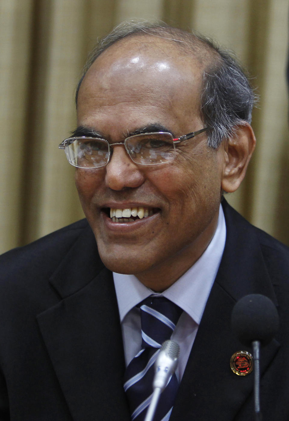 Reserve Bank of India (RBI) Governor Duvvuri Subbarao smiles during a meeting with bankers at the RBI head office in Mumbai, India, Tuesday, April 17, 2012. The RBI slashed India's key interest rate by half a percentage point Tuesday, the first cut in three years and more than economists had expected. (AP Photo/Rafiq Maqbool)