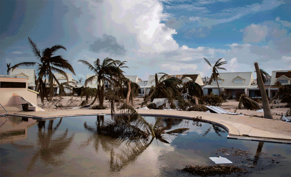 A pool surrounded by wrecked bungalows in Marigot on Sept. 10 and the same pool filled with sand on Feb. 28.