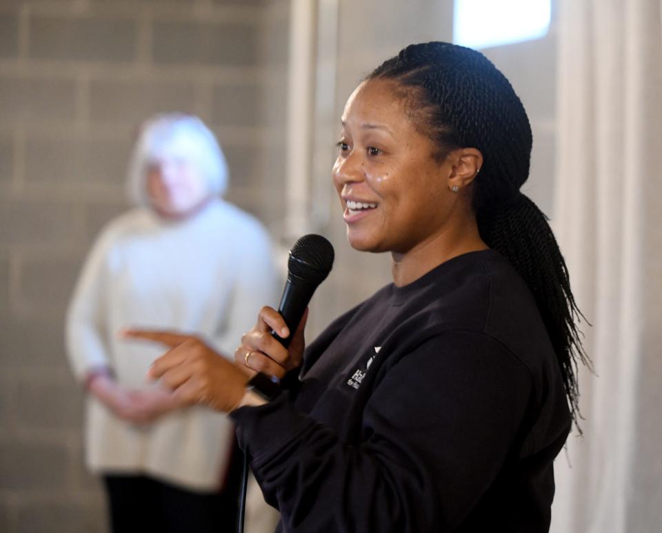 Courtney Brown, with Habitat for Humanity East Central Ohio, speaks during a ceremony Thursday to dedicate the Canton home of Ronnie Dykes and Ashya Mathis and their sons Josiah, 14, Jay'On, 12, and Jaiaire, 11.