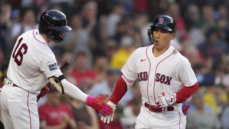 Boston Red Sox's Masataka Yoshida is congratulated by Jarren Duran (16) after Yoshida's solo home run during the second inning of the team's baseball game against the Cincinnati Reds at Fenway Park, Wednesday, May 31, 2023, in Boston. (AP Photo/Charles Krupa)