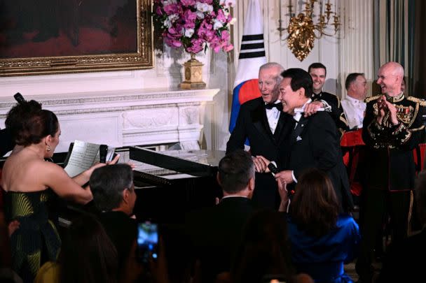 PHOTO: President Joe Biden embraces South Korean President Yoon Suk Yeol onstage during a state dinner at the White House, April 26, 2023. (Brendan Smialowski/AFP via Getty Images)