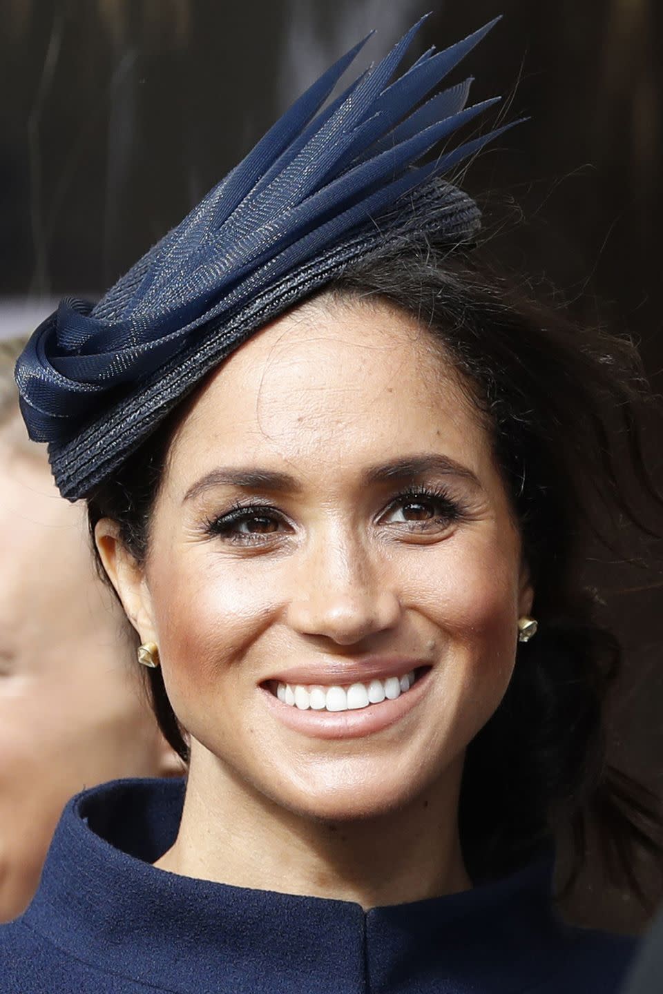 Meghan working nude lips and a fascinator in 2018