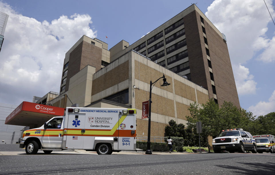 University Hospital, Camden Division, ambulances and emergency trucks rush to the emergency room at Cooper University Hospital Tuesday, July 7, 2015, in Camden, N.J. New Jersey Gov. Chris Christie has signed a bill that will overhaul who runs emergency paramedic services in the city of Camden. Currently, the Newark-based University Hospital provides ambulances in the city, while the Marlton-based Virtua provides paramedics, who provide care for patients but not transportation. The new law will give the state's three, including Cooper, Level 1 trauma centers exclusive rights to provide both kinds of emergency medical services in their cities. (AP Photo/Mel Evans)