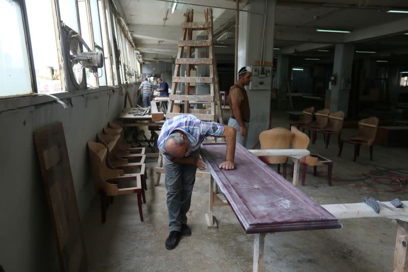 Men work inside Sleep Comfort furniture factory that was damaged during the Beirut port blast