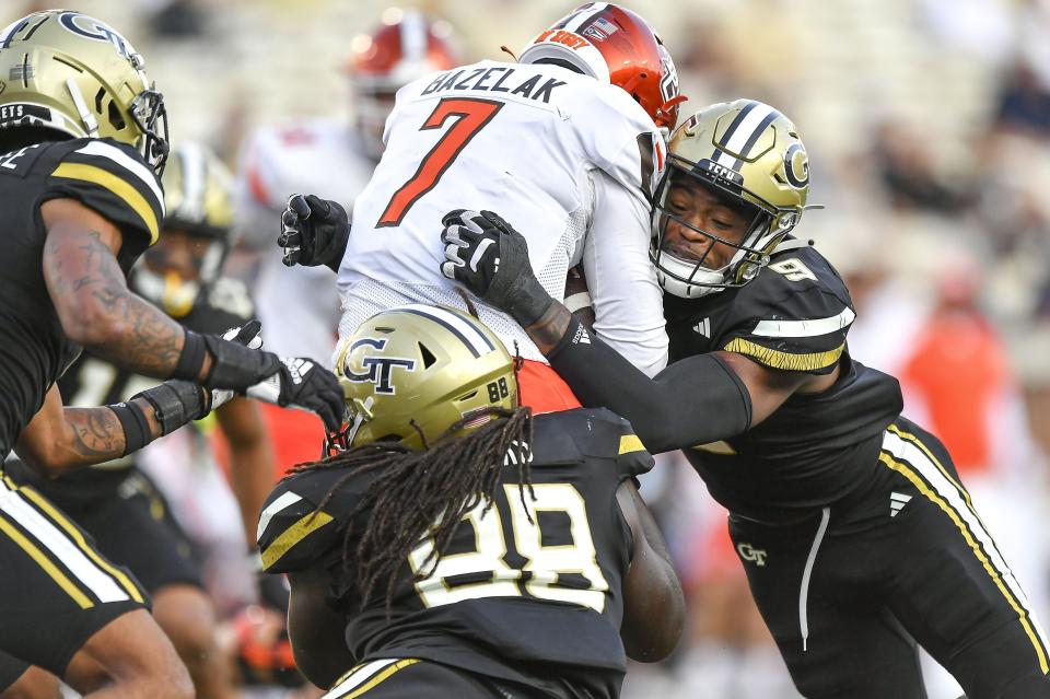 Georgia Tech defensive linemen Zeek Biggers (88) and Kyle Kennard (9) sack Bowling Green quarterback Connor Bazelak (7) in the backfield in the fourth quarter of an NCAA college football game, in Atlanta, Saturday, Sept. 30, 2023. (Daniel Varnado/Atlanta Journal-Constitution via AP)