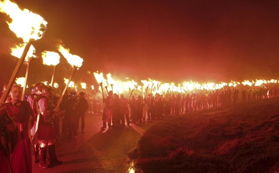 In this photo taken March 14, 2014, locals dressed as Vikings carry torches as they take part in the annual Up Helly Aa, Viking fire festival in Gulberwick, Shetland Islands north of mainland Scotland. The fearsome-looking participants in the festival live in Scotland's remote Shetland Islands, a wind-whipped northern archipelago where many claim descent from Scandinavian raiders. They are cool to the idea of Scotland leaving Britain to form an independent nation, and determined that their rugged islands will retain their autonomy whatever the outcome of September’s referendum. (AP Photo/Jill Lawless)