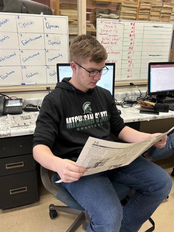 Evan Parfitt reading through the school newspaper, The Index.