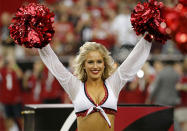 An Arizona Cardinals cheerleader performs during the first half of an NFL preseason football game against the Houston Texans.
