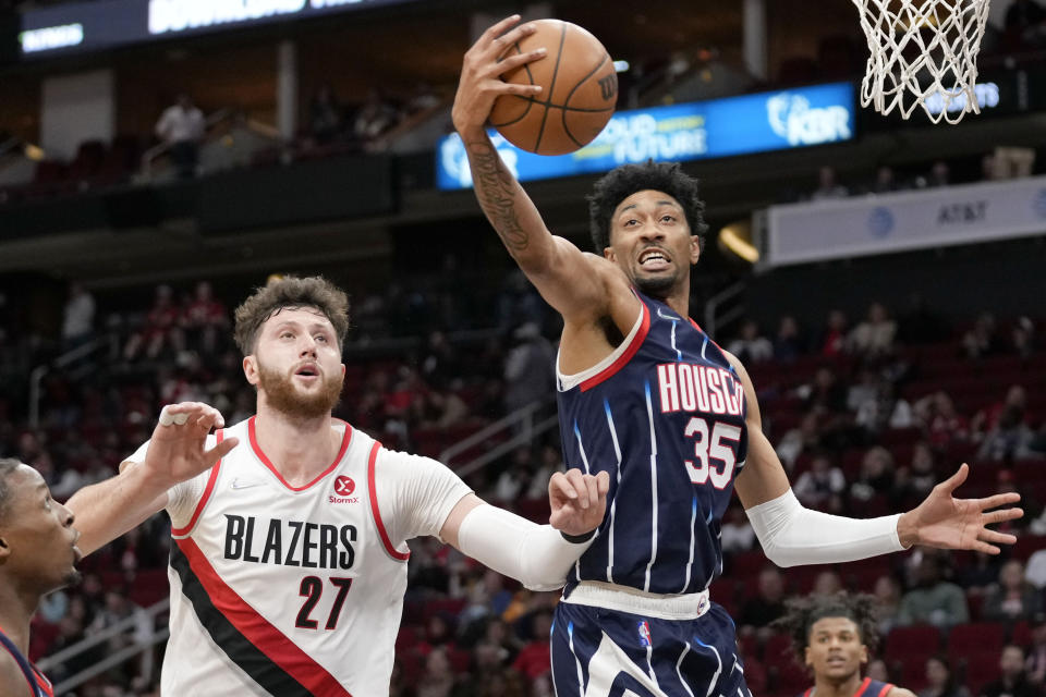 Houston Rockets center Christian Wood (35) grabs a rebound from Portland Trail Blazers center Jusuf Nurkic (27) during the first half of an NBA basketball game, Friday, Jan. 28, 2022, in Houston. (AP Photo/Eric Christian Smith)