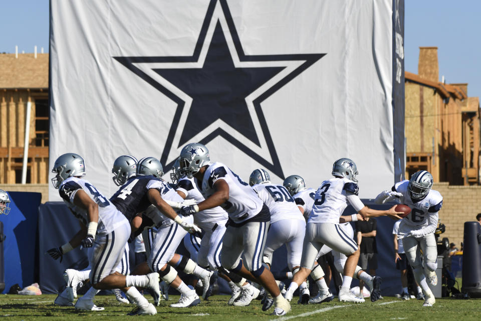 FILE - In this Monday, July 29, 2019, file photo, Dallas Cowboys practice at the NFL football team's training camp in Oxnard, Calif. The coronavirus pandemic forced the NFL to abandon, at least for 2020, the fading but still time-honored tradition of teams traveling to training camp. (AP Photo/Michael Owen Baker, File)