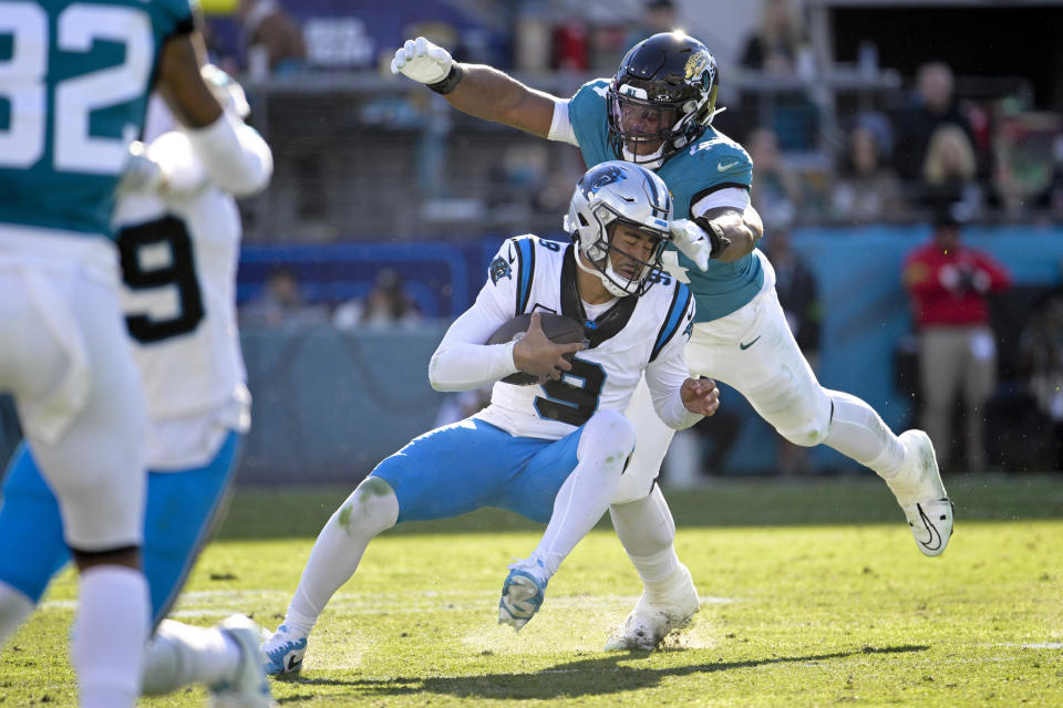 Carolina Panthers quarterback Bryce Young is sacked by Jacksonville Jaguars linebacker Travon Walker during the second half of an NFL football game Sunday, Dec. 31, 2023, in Jacksonville, Fla. (AP Photo/Phelan M. Ebenhack)