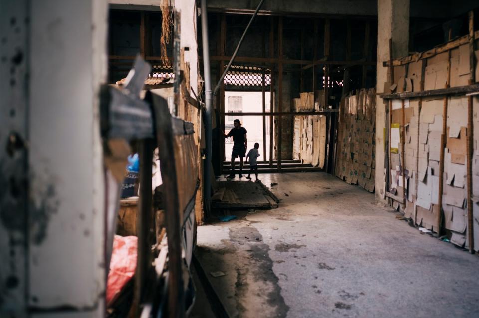 A young Cuban man and child play in the hallway of an abandoned building (James Clifford Kent/The Conversation)