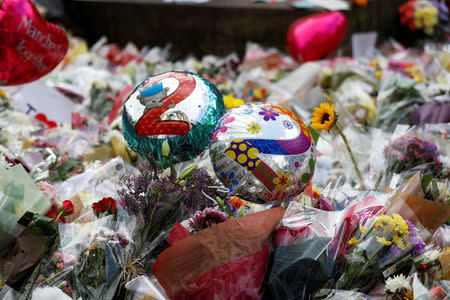 FILE PHOTO: Balloons and floral tributes for the victims of the attack on the Manchester Arena are seen in St Ann's square in Manchester, Britain, May 24, 2017. REUTERS/Peter Nicholls/File Photo