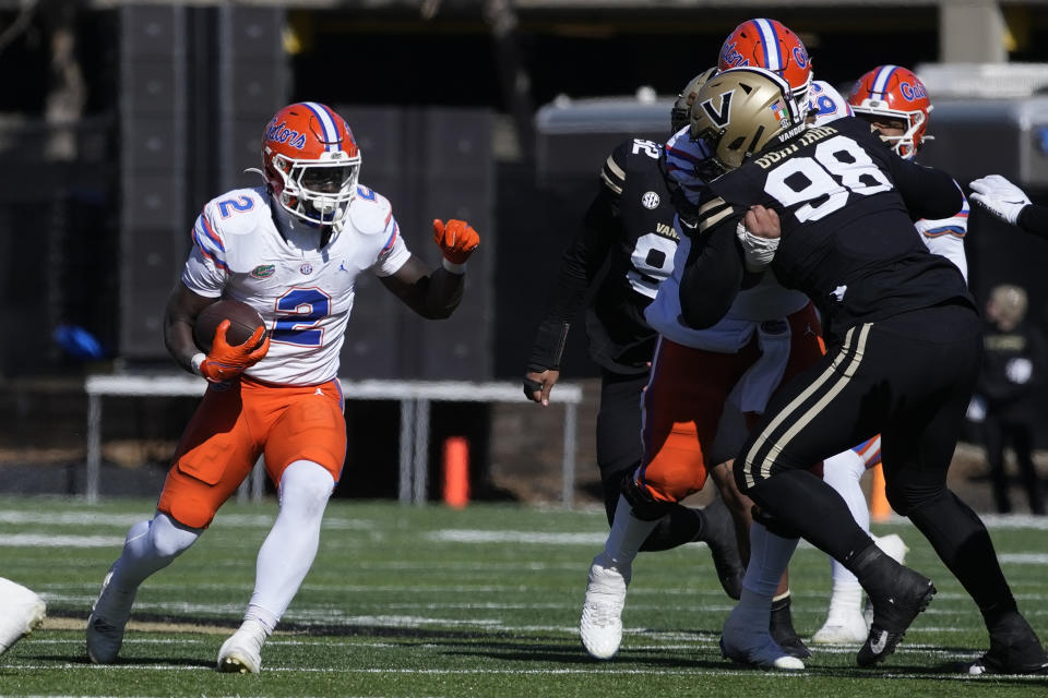 Florida running back Montrell Johnson Jr. (2) runs against Vanderbilt defensive lineman Yilanan Outtara (98) in the first half of an NCAA college football game Saturday, Nov. 19, 2022, in Nashville, Tenn. (AP Photo/Mark Humphrey)