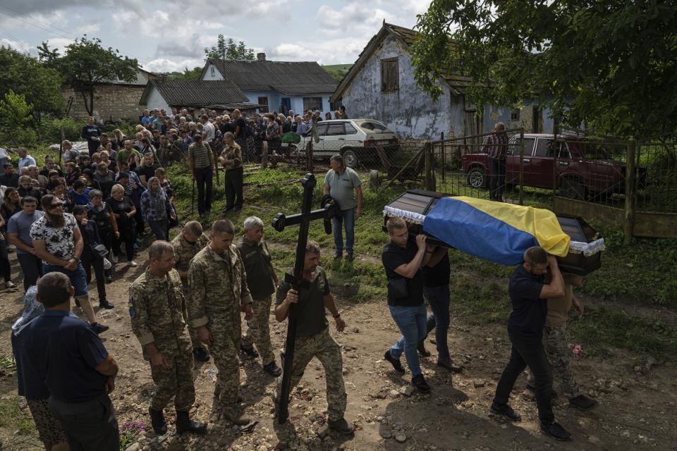 People carry the coffin of Ukrainian serviceman Bohdan Kobylianskyi who was killed in Donbas, during funeral ceremony in Dusaniv, Ukraine, on July 22, 2023.