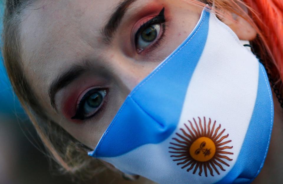 A woman wears a face mask with the colors of the Argentine flag colors during a protest against how the government of President Alberto Fernandez is handling of the new coronavirus pandemic crisis, in Buenos Aires,  on May 25.