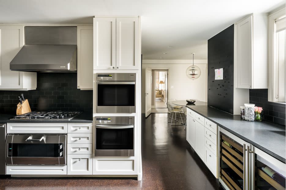 The kitchen includes two wine refrigerators, two ovens, and space for a large table.