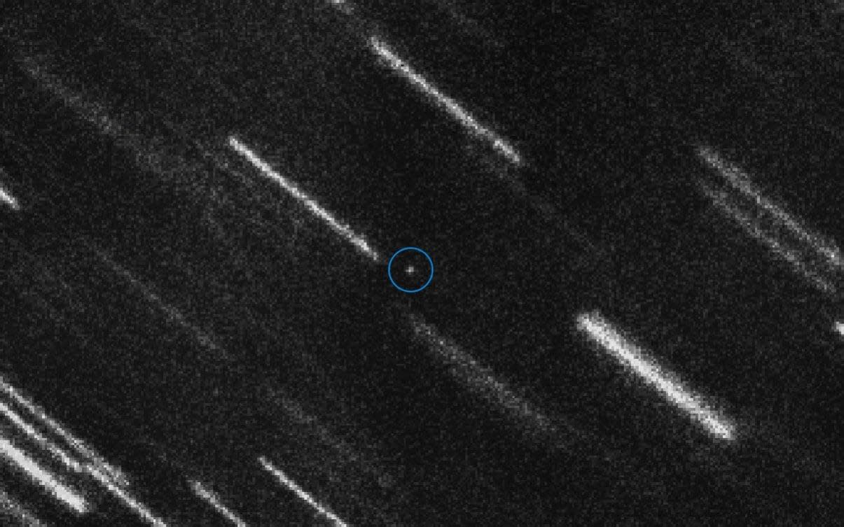 Asteroid 2012 TC4 appears as a dot at the centre of this composite of 37 individual 50-second exposures obtained by the European Space Agency. - AFP