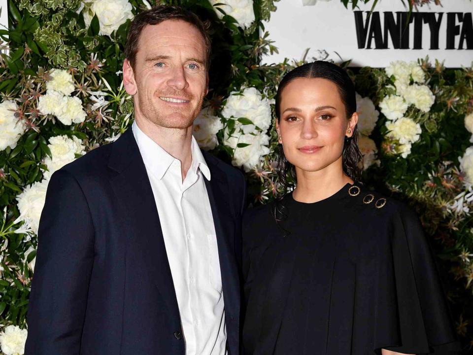 <p>Dominique Charriau/WireImage</p> Michael Fassbender and Alicia Vikander attend the Vanity Fair x Louis Vuitton dinner during the 75th annual Cannes Film Festival in May 2022.