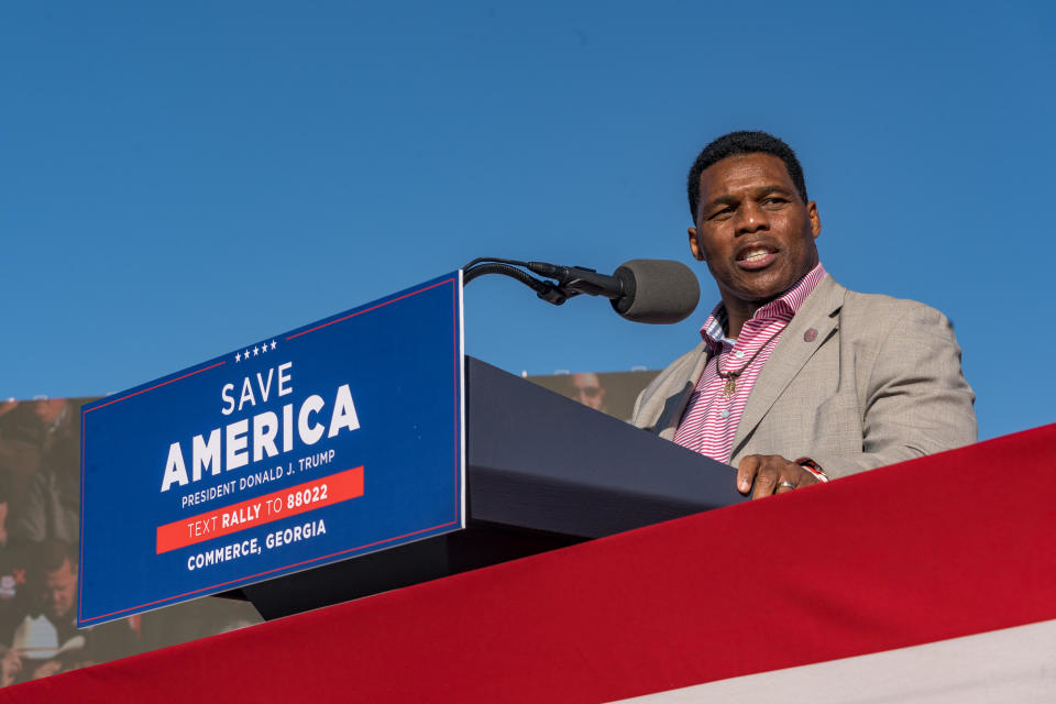 Former Heisman Trophy winner and candidate for US Senate Herschel Walker (R-GA) speaks to supporters of former U.S. President Donald Trump during a rally at the Banks County Dragway on March 26, 2022 in Commerce, Georgia.  / Credit: Megan Varner / Getty Images