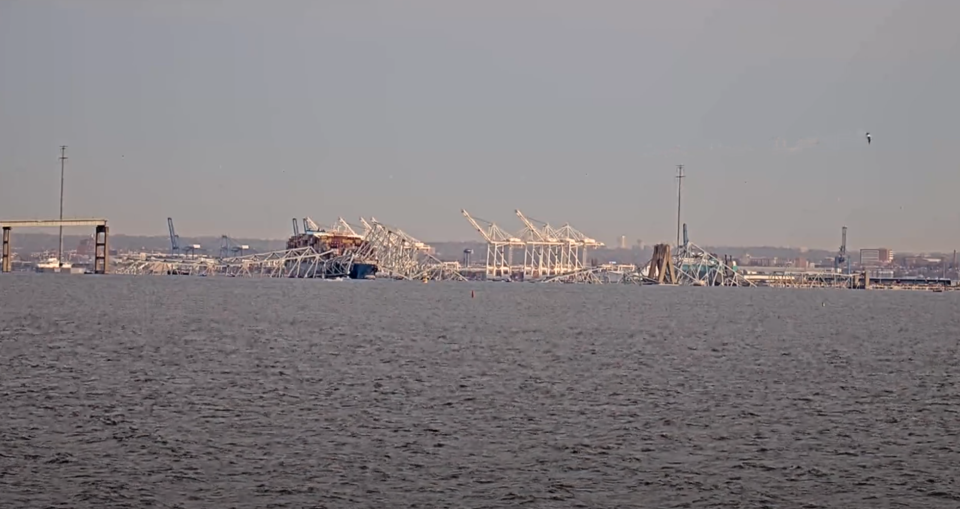 The collapsed section of the Francis Scott Key Bridge in Baltimore is seen more clearly after daybreak. (Photo: StreamTime Live/YouTube)