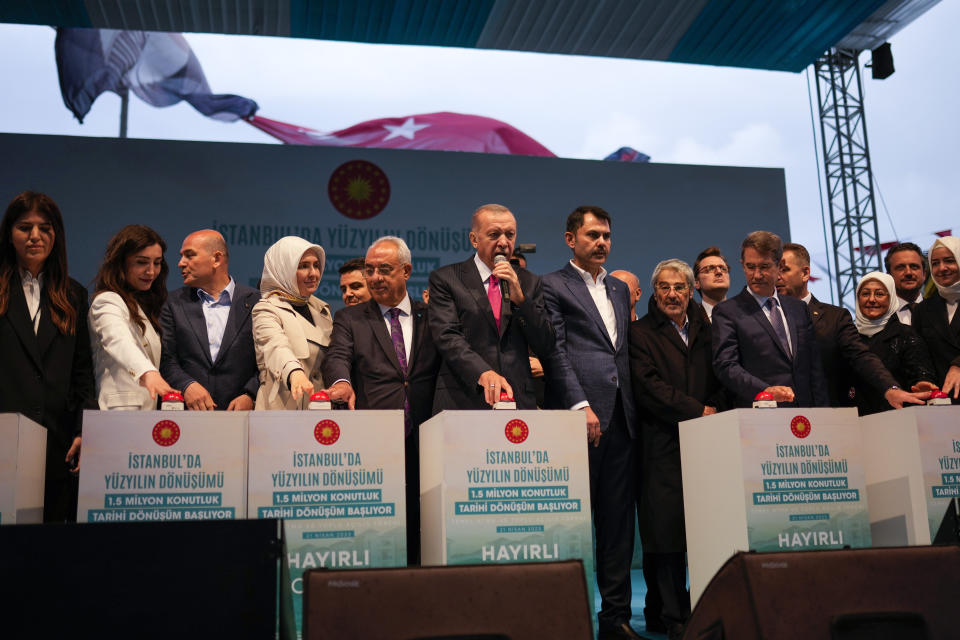 Turkish President and People's Alliance's presidential candidate Recep Tayyip Erdogan, center, launches the start of a new construction housing mega project during an election rally campaign in Istanbul, Turkey, Friday, April 21, 2023. (AP Photo/Francisco Seco)