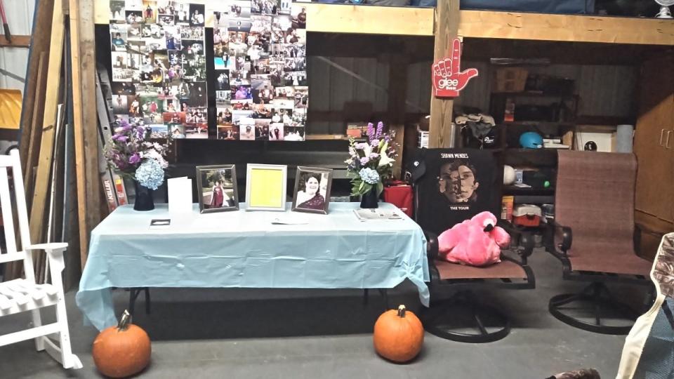 A memorial for Jamie Malinowski, who died in November of COVID-19, shows her favorite pink flamingo, the pumpkins she had hoped to carve for Halloween this year and photos of her with her family.