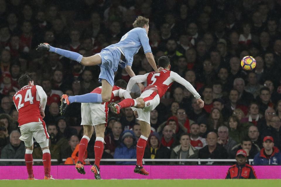 Stoke City's Peter Crouch, top, climbs for a header on goal during the English Premier League soccer match between Arsenal and Stoke City at the Emirates stadium in London, Saturday Dec. 10, 2016. (AP Photo/Tim Ireland)