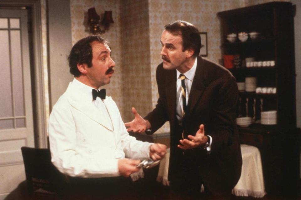 Andrew Sachs as Manuel and John Cleese as Basil in the BBC’s Fawlty Towers (PA Media)