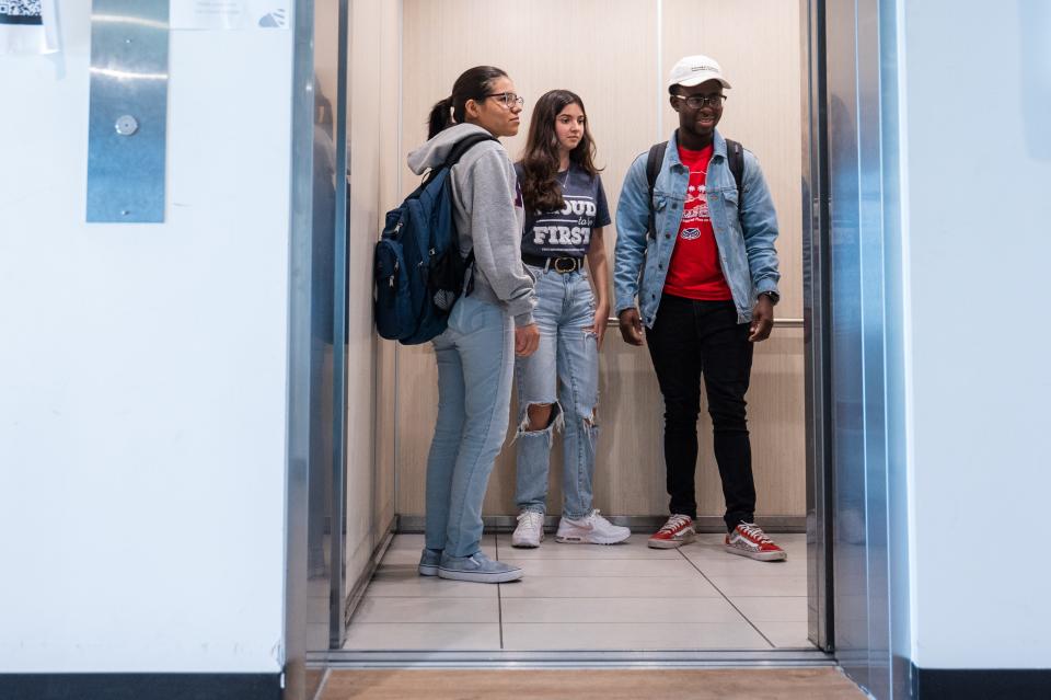 Florida Atlantic University students Natalia Escovar, left, Esther Consuegra and Dodlee Mosilme ride an elevator down to the ground floor of their dorm building, Atlantic Park Towers, on Wednesday, October 25, 2022, in Boca Raton, FL. The students are part of the Kelly/Strul Emerging Scholars Program, which pays the college costs - tuition, books, housing and meals - of first-generation, low-income students so they can graduate debt free.