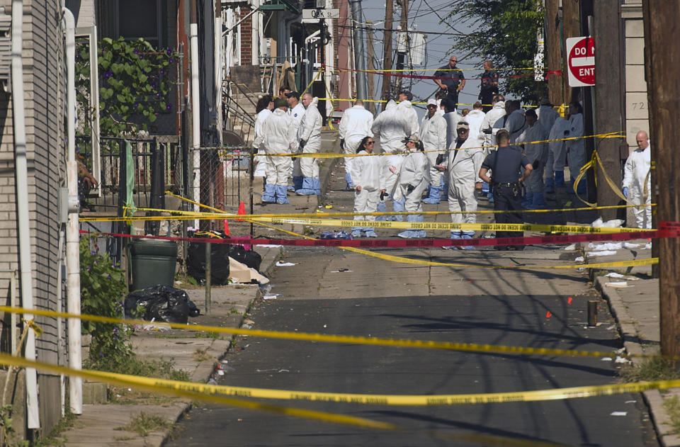 Federal and local authorities investigate along North Hall Street in Allentown, Pa., Sunday, Sept. 30, 2018, after a fiery car explosion rocked the neighborhood on Saturday night. Police confirmed several fatalities. (Harry Fisher/The Morning Call via AP)