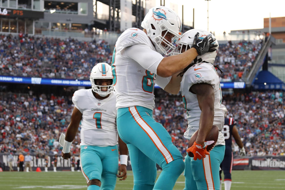 Miami Dolphins wide receiver Jaylen Waddle, right, celebrates with Mike Gesicki after his touchdown during the second half of an NFL football game against the New England Patriots, Sunday, Sept. 12, 2021, in Foxborough, Mass. At left is Miami Dolphins quarterback Tua Tagovailoa (1). (AP Photo/Winslow Townson)