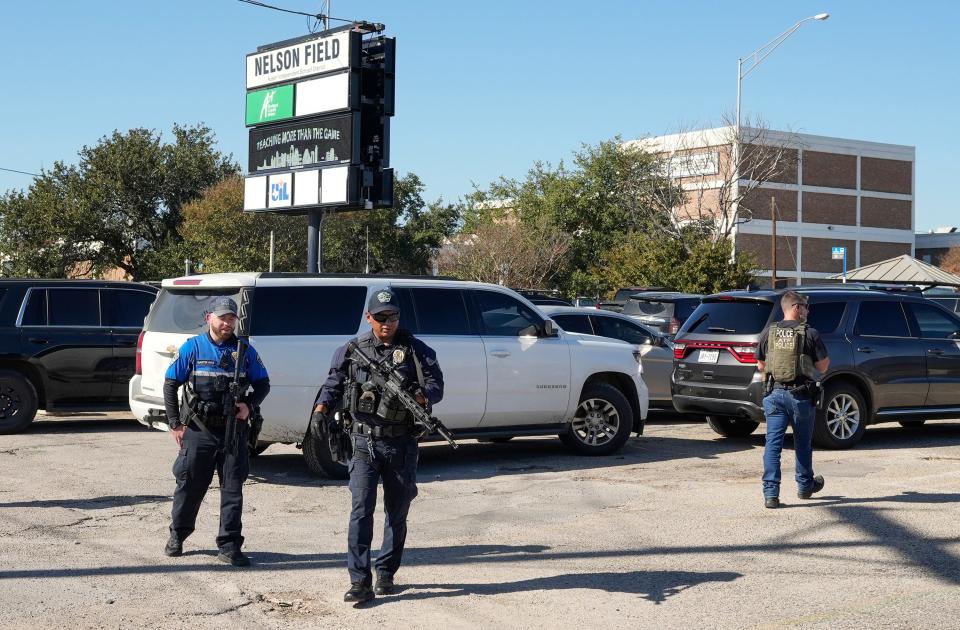 Austin police officers secure the scene after a shooting outside Northeast Early College High School on Tuesday.