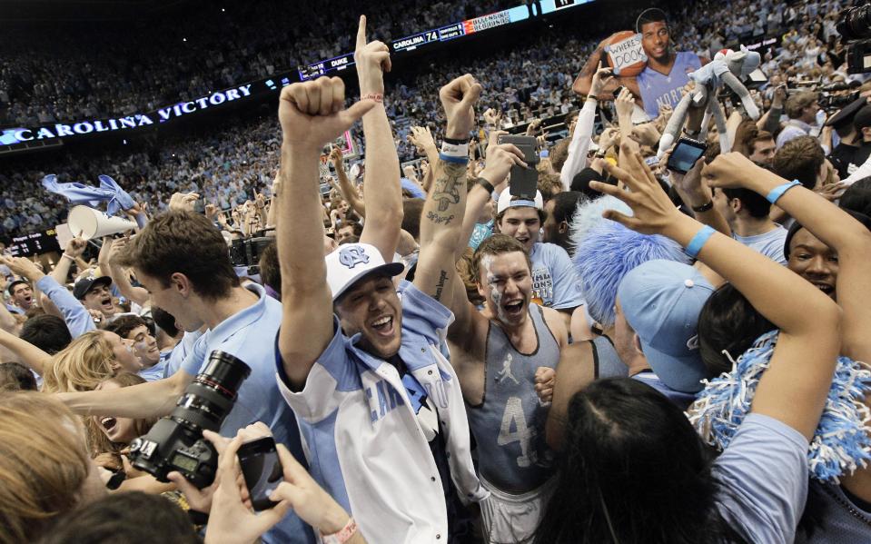 Fans rush the playing court following North Carolina's 74-66 win over Duke in an NCAA college basketball game in Chapel Hill, N.C., Thursday, Feb. 20, 2014. (AP Photo/Gerry Broome)