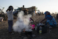 Tigray refugees who fled the conflict in the Ethiopia's Tigray prepare breakfast for their families at Hamdeyat Transition Center near the Sudan-Ethiopia border, eastern Sudan, Thursday, Dec. 3, 2020. Ethiopian forces on Thursday blocked people from the country's embattled Tigray region from crossing into Sudan at the busiest crossing point for refugees, Sudanese forces said.(AP Photo/Nariman El-Mofty)